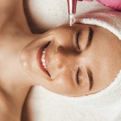 Beautiful,Attractive,Female,Patient,Smiling,While,Receiving,Face,Oxygen,Peeling